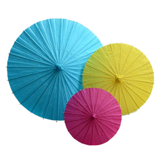 Set of hanging paper umbrellas in blue, yellow, and pink with round canopies