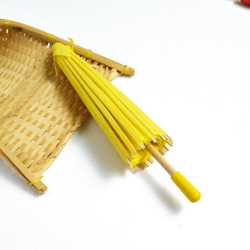 Yellow hanging paper umbrella decoration with bamboo handle and pleated canopy ribs