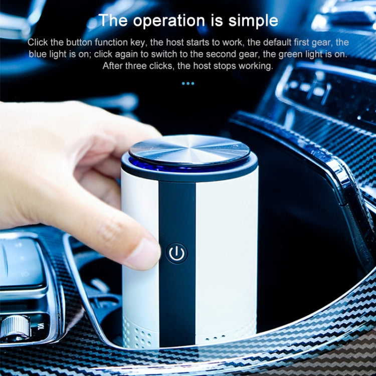 Blue-lit top cylindrical car air purifier with power button, being pressed