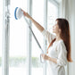 Telescopic window cleaner with round blue brush head used on a window frame