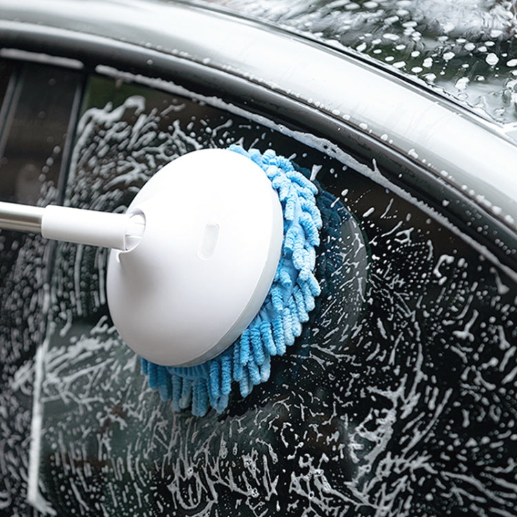 Electric window cleaner brush head with blue pad scrubbing a car windshield