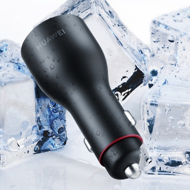 Black car USB charger with red accent ring, shown near water droplets