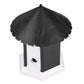 Outdoor bark control training house with black peaked roof and side oval access opening