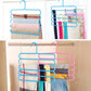 Blue and pink 5-layer plastic hangers on a closet rod with folded fabrics