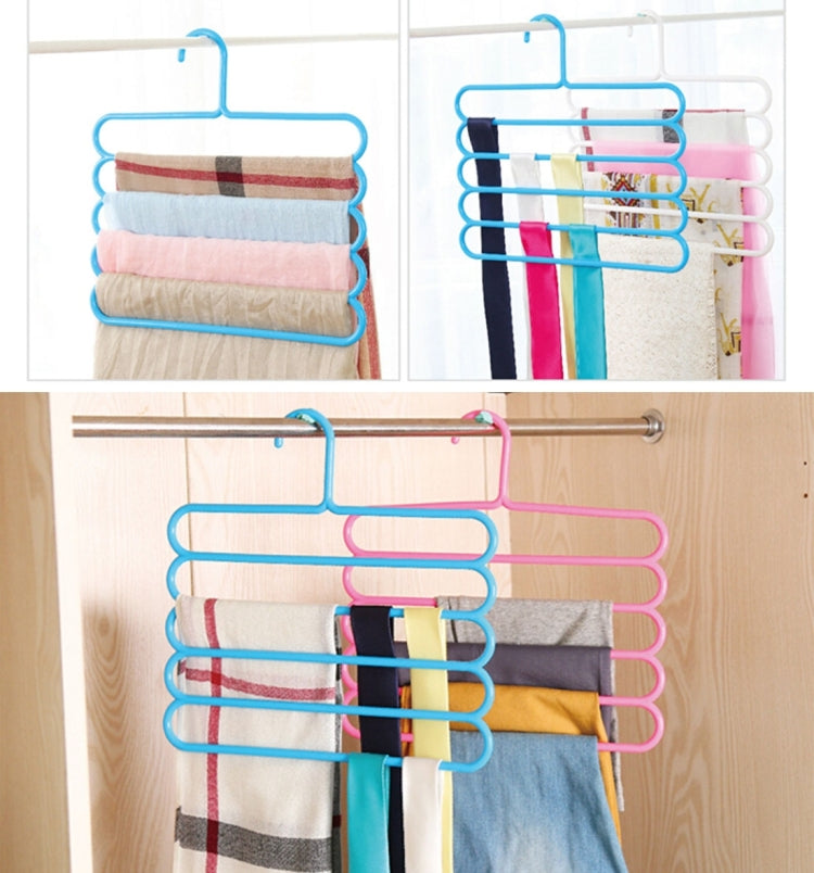 Blue and pink 5-layer plastic hangers on a closet rod with folded fabrics