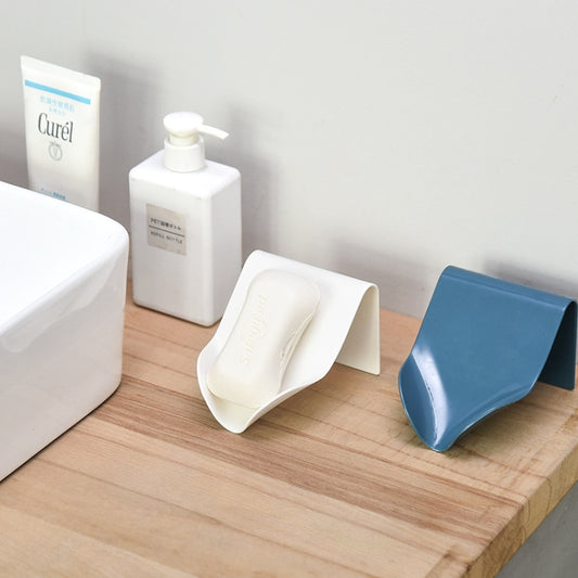 Wall-mounted soap drain boxes in white and blue on a wooden counter