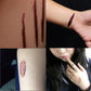Temporary scar tattoos on arm and hand: dark scratches and a bruised wound