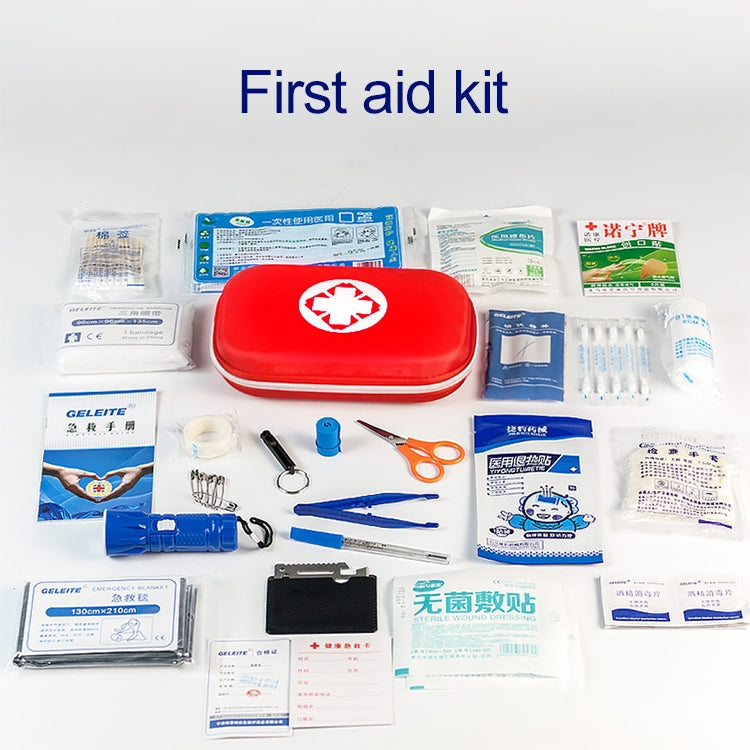 Red first aid kit case with medical supplies and bandages laid out around it