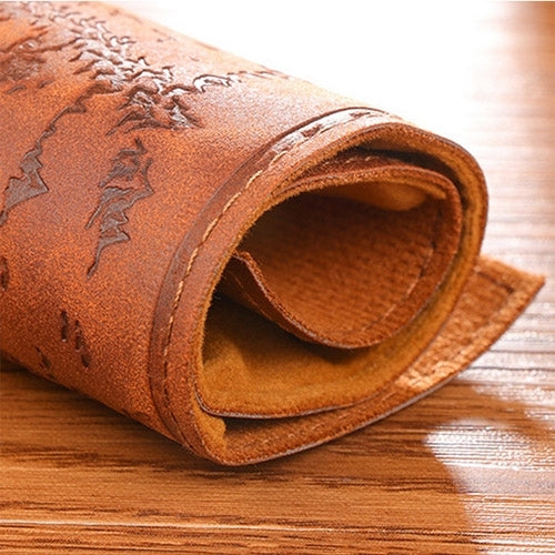 Orange-brown leather pencil roll with embossed map pattern and folded edge pocket