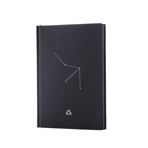 Dark cover paper notebook with constellation line art and small zodiac symbol
