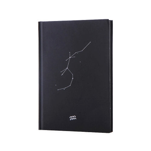 Black paper notebook cover with constellation line art and small three-star symbol at bottom
