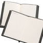 Open black notebook with two pages of ruled lines and visible inner cover