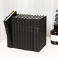 Black notebook set standing upright with printed constellation icons on spines