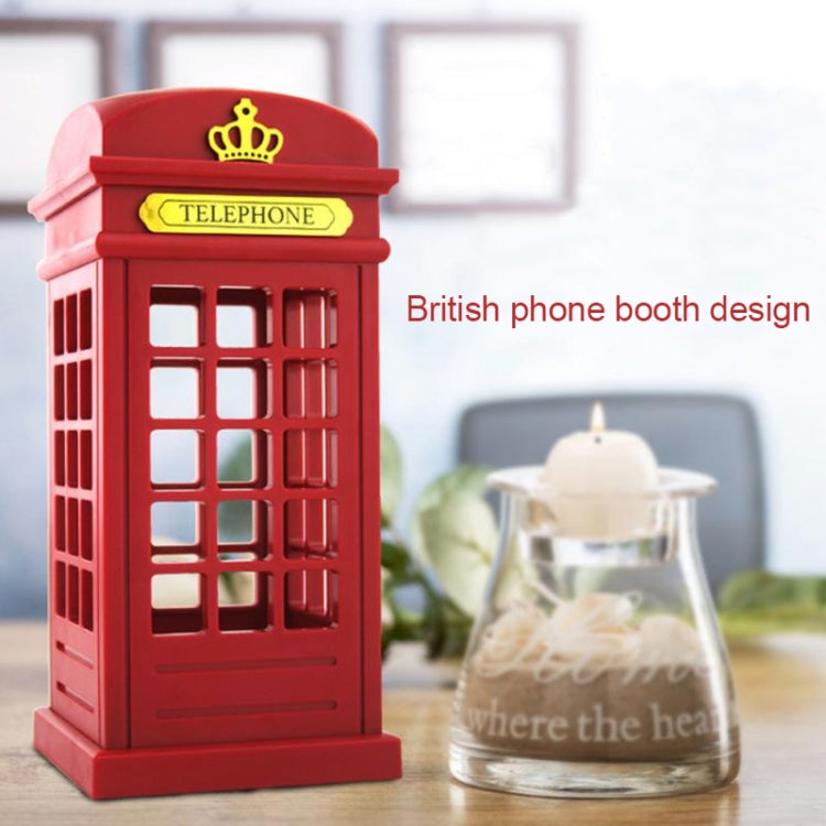 Red phone booth lamp with crown and glowing windows, bedside setup.