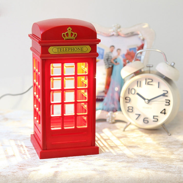 Red glowing phone booth lamp with crown, bedside night light style.
