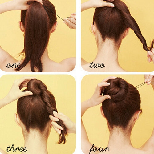 Person using hair pins to secure a braided bun at the back of the head