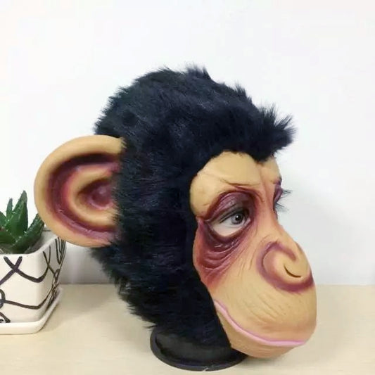Gorilla mask side view with black plush hood and sculpted brown-and-pink face