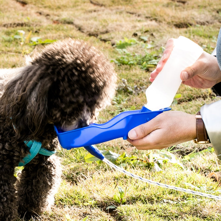 Blue 250ml portable pet water bottle squeezed to pour water into a dog’s bowl
