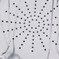 Close-up of perforated stainless steel toast tray with small round drainage holes