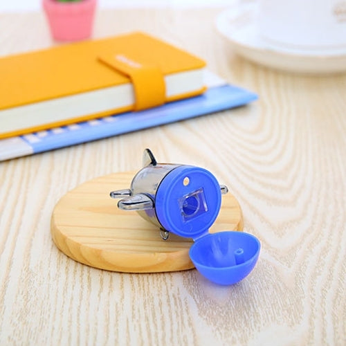 Blue aircraft-style pencil sharpener with clear metal cutter on round wooden base