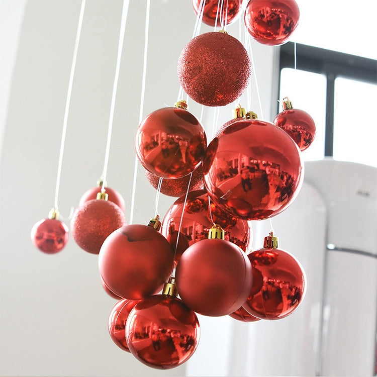 Hanging red and burgundy plastic ornament balls with gold-tone caps and hooks.