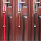 Colorful dog doorbell leash straps with silver bells hanging on door handles