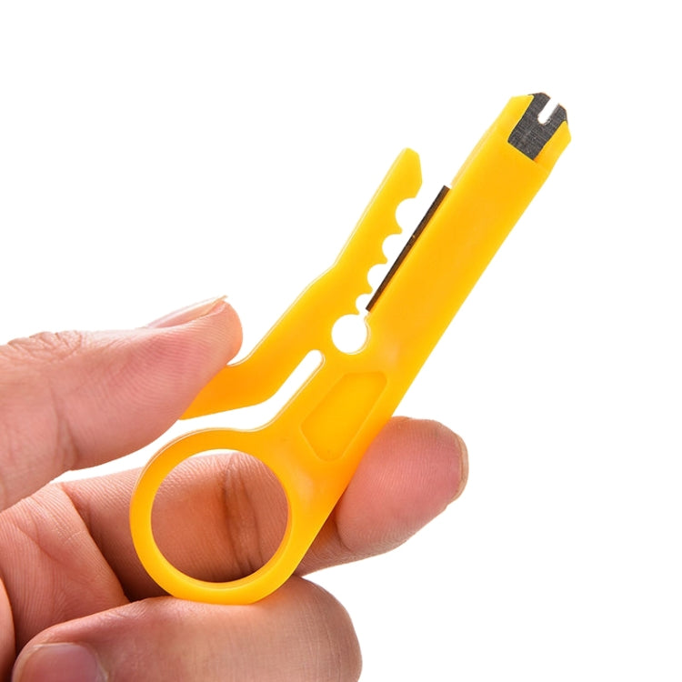 Yellow cable punch down tool held in hand, showing blade openings