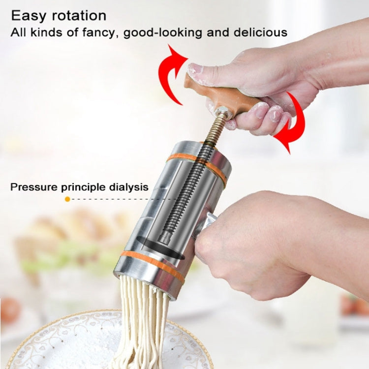 Handheld noodle press with orange handle and stainless barrel dispensing pressed noodles