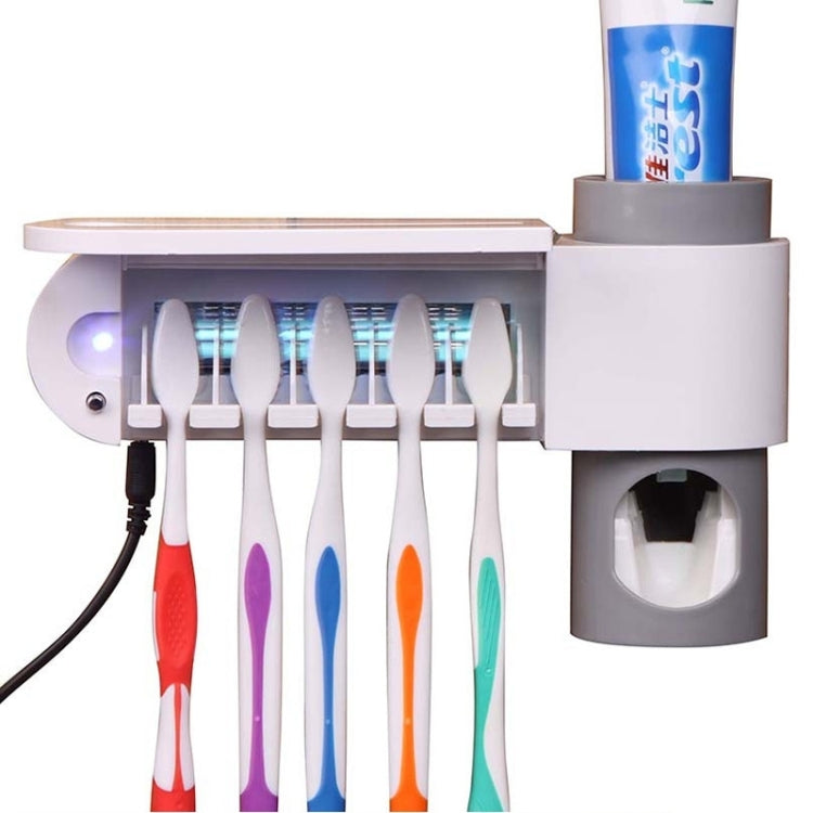 Automatic toothpaste dispenser with UV light bar and toothbrush rack, tube holder on top