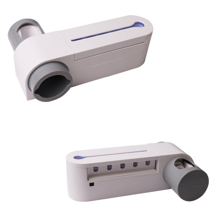 White UV toothbrush sterilizer with toothpaste dispenser and gray charging cradle