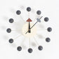 Wall clock with dark ball arms, cream face, black hands and triangular pointer accents