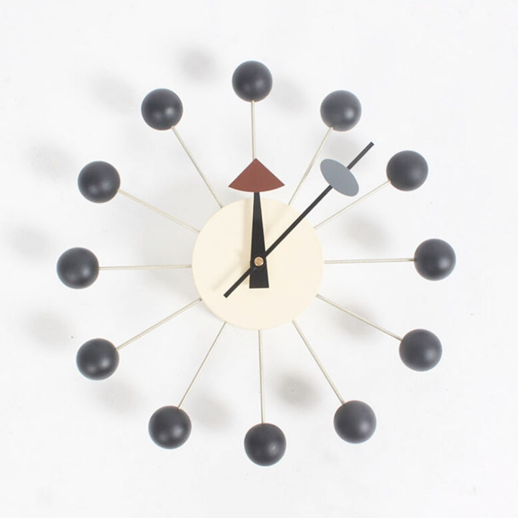 Wall clock with dark ball arms, cream face, black hands and triangular pointer accents