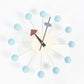 Wall clock with light blue ball arms, cream face, black hands and triangular accents