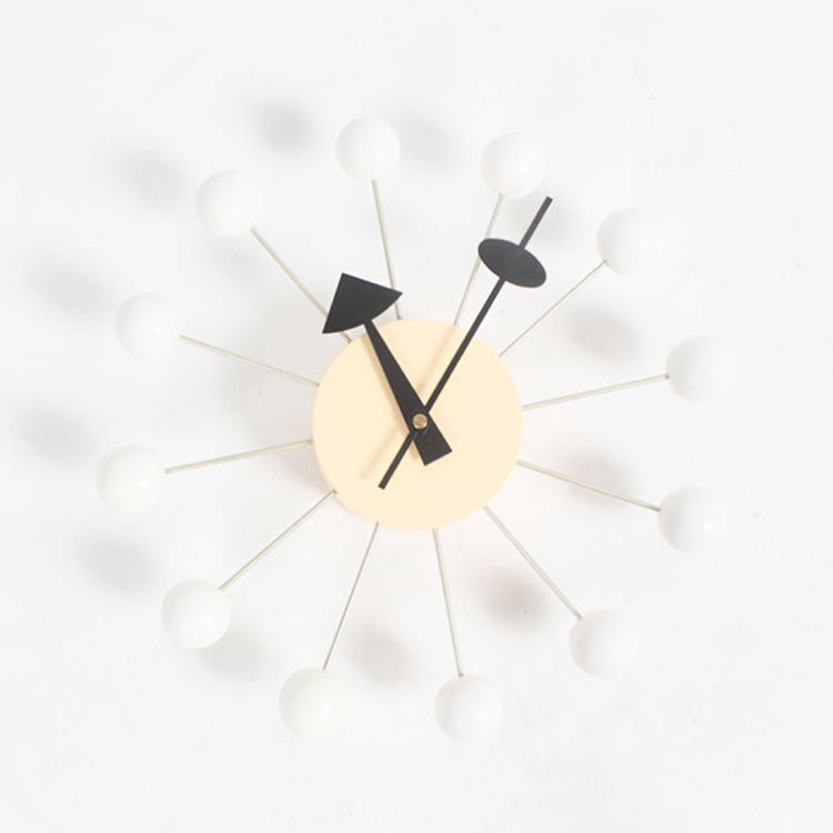 Wall clock with white ball arms, cream face, black hands and triangular pointer