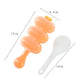 Orange spoon-shaped sushi rice ball mold with three rounded compartments and paddle