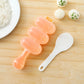 Peach spoon-shaped sushi rice ball mold with three round compartments and textured paddle