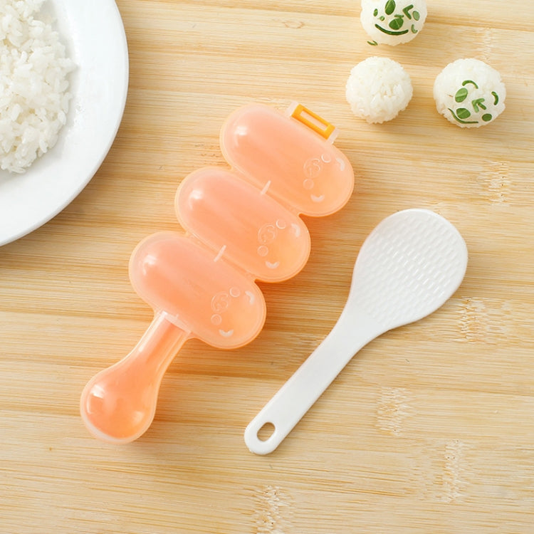Peach spoon-shaped sushi rice ball mold with three round compartments and textured paddle