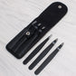 Black fabric pouch with two eyebrow scissors and one compact comb tool