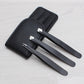 Three black eyebrow scissors with stainless tips stored in a black faux-leather case
