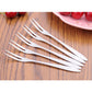 Stainless steel fruit forks, nine forks laid out with narrow prongs