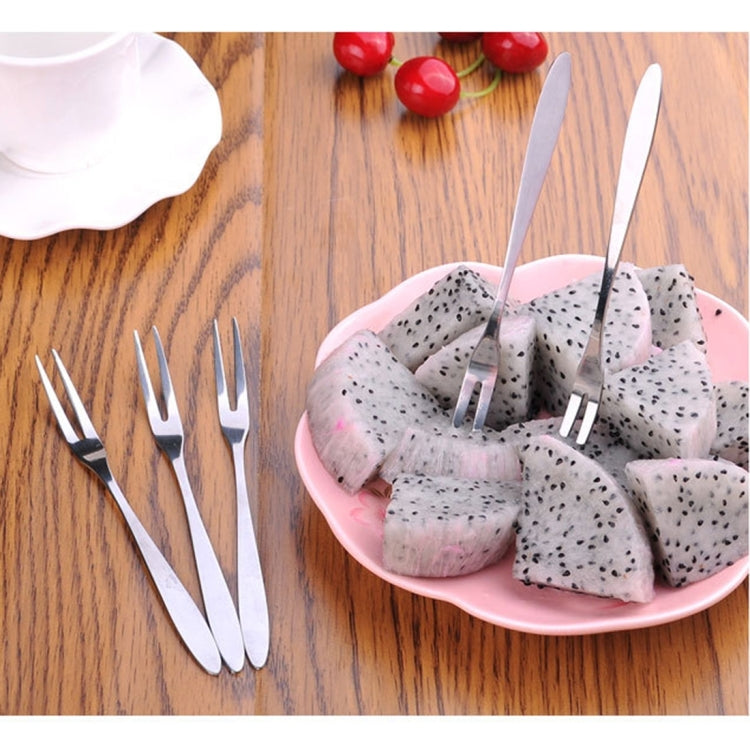 Stainless steel fruit forks set with slim prongs standing in dragon fruit bowl