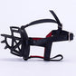Black dog muzzle with wide blue strap and red inner padding, adjustable buckle