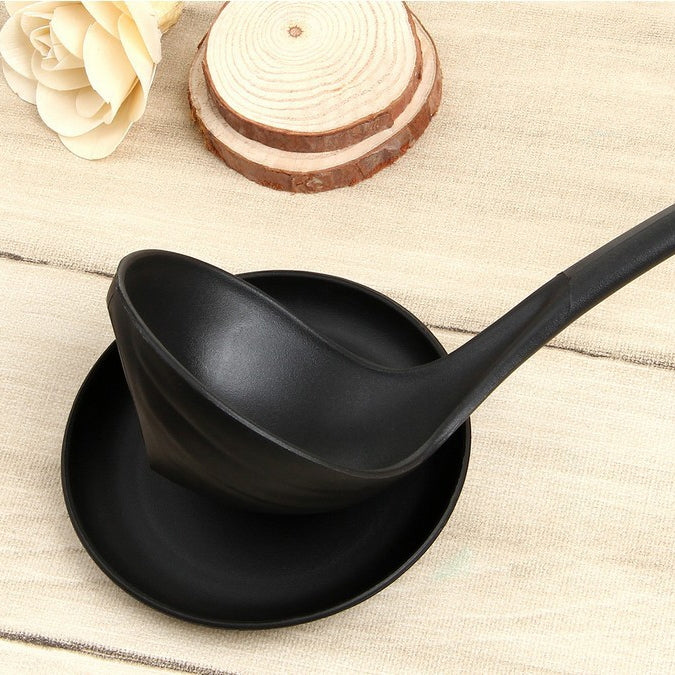 Black ladle stand with wide spoon rest tray and contoured bowl support