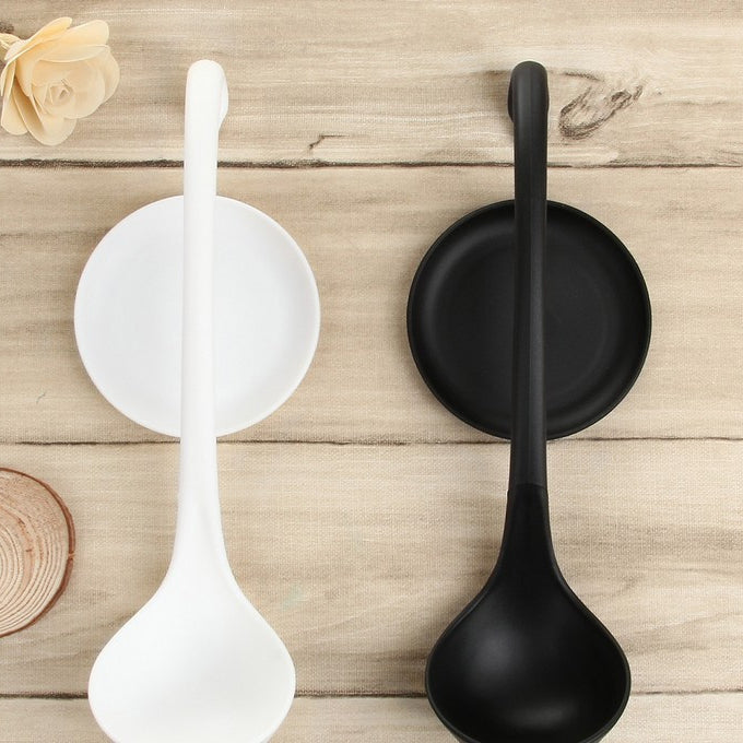 Two ladle stands in white and black, each with curved rest and round base
