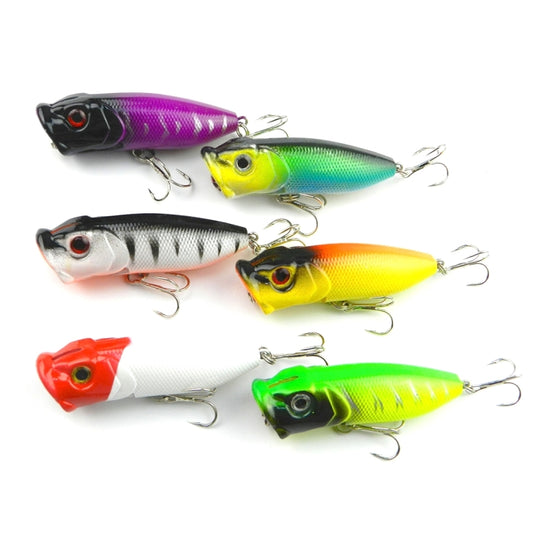 Set of plastic popper fishing lures with treble hooks, multicolor finishes.
