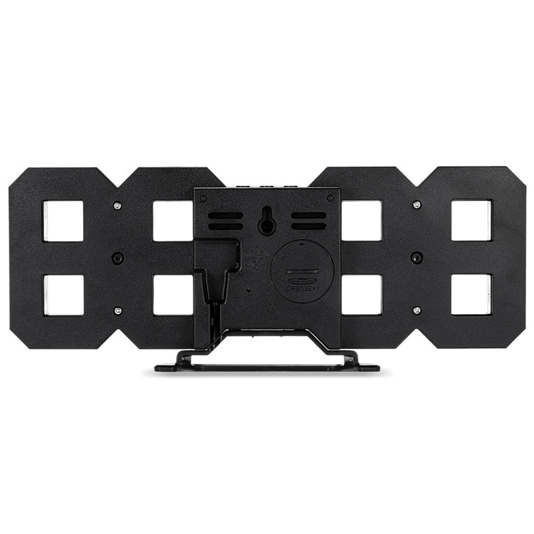 Black back plate of an LED digital wall alarm clock with mounting holes and controls