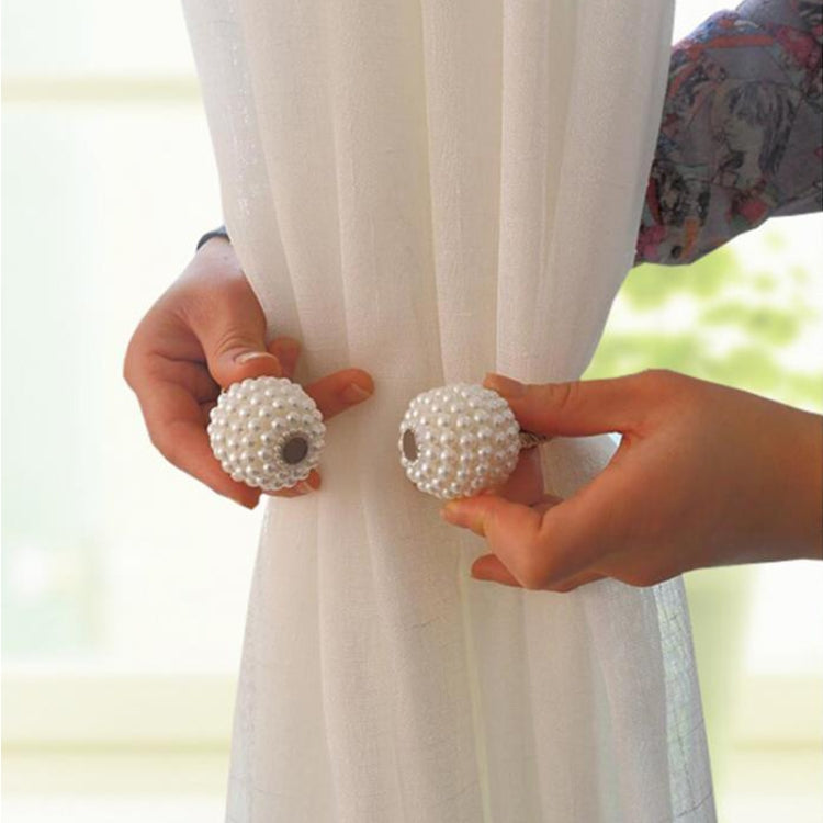 Pair of pearl magnetic curtain tiebacks with braided strap on sheer curtain