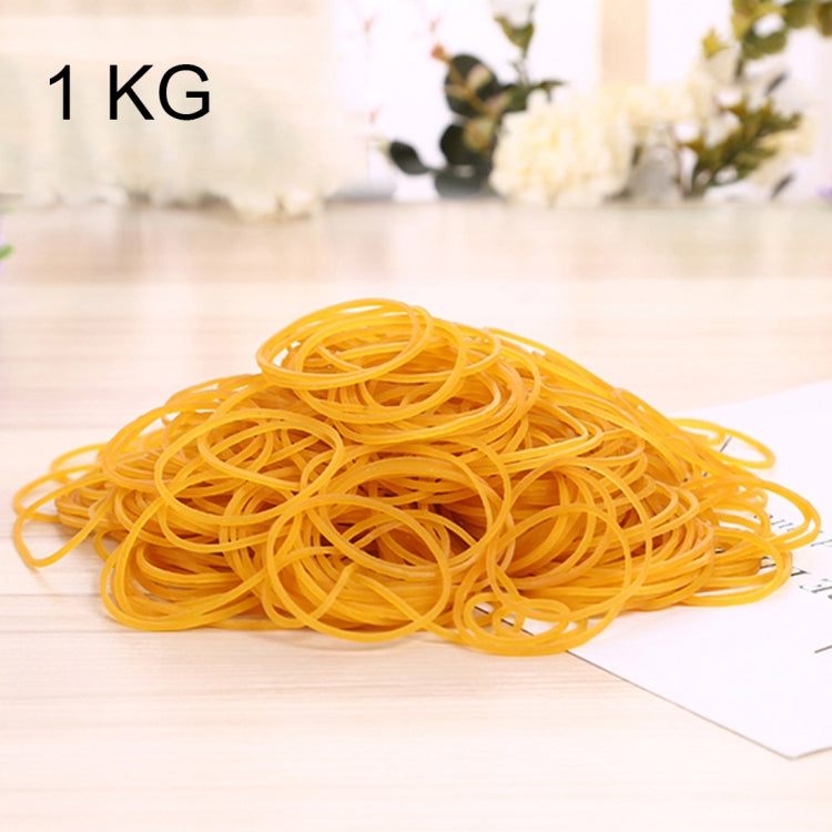 Yellow elastic rubber bands, loose coil on a white sheet