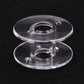 Clear plastic bobbin spool with round discs and center hub for sewing machine