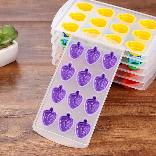 Stacked silicone ice cube trays: purple grape molds and yellow cavities